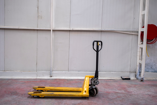 hand pallet truck, in the warehouse part of the factory. Selective Focus pallet truck