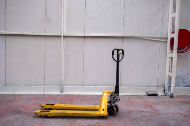 hand pallet truck hand pallet truck, in the warehouse part of the factory. Selective Focus pallet truck pallet jack handle stock pictures, royalty-free photos & images