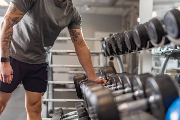 istock Close-up of man's hands taking dumbbell 1399006228