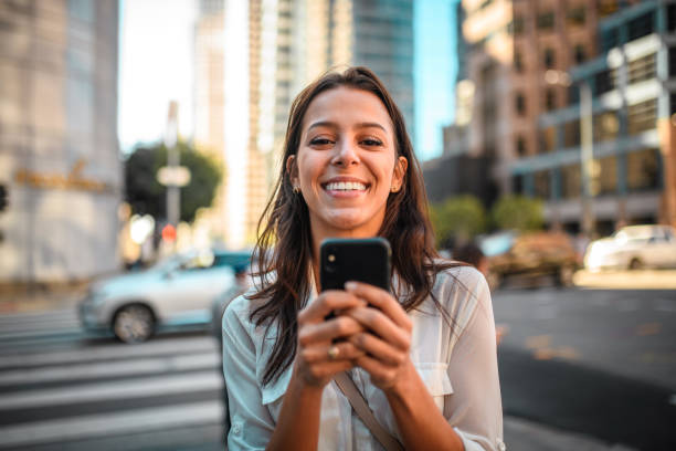 istock Cheerful Latin Female in Late 20's Using a Smartphone 1399006637