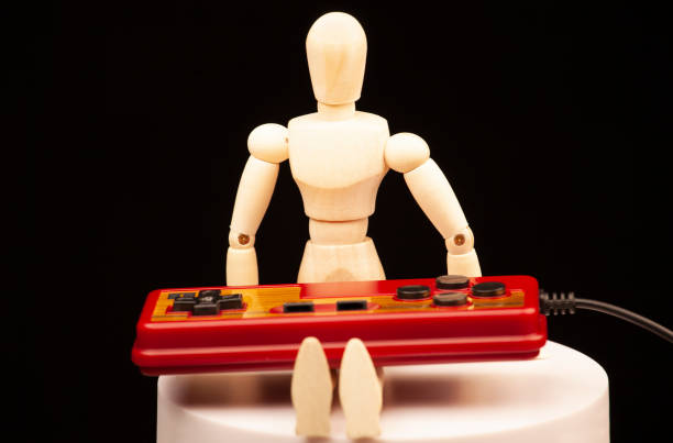 istock image of wooden mannequin game controller dark background 1399006699