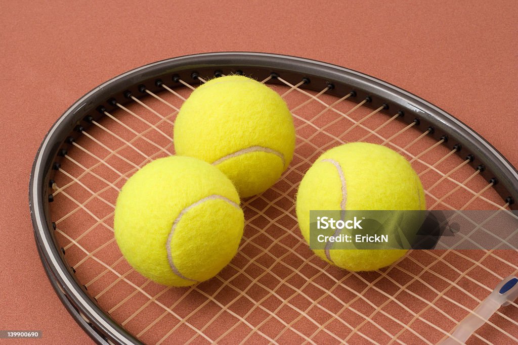Tennis balls and racket Three tennis balls on a racket head Circle Stock Photo