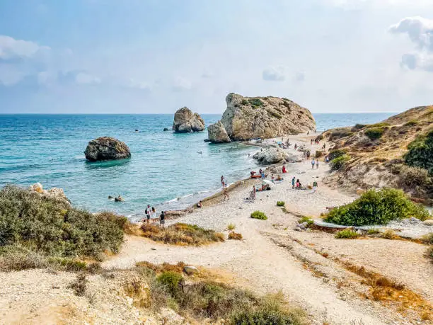 People at the Birthplace of Aphrodite, one of the most beautiful beaches near the city of Paphos, Kouklia, Cyprus in afternoon.