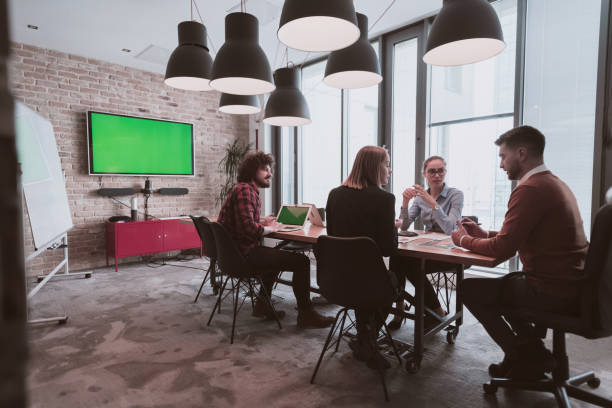 istock Successful team. Group of young multi-ethnic business people working and communicating together in creative office. Selective focus 1399008462
