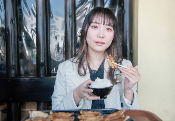 istock woman eating the gyoza 1399008573