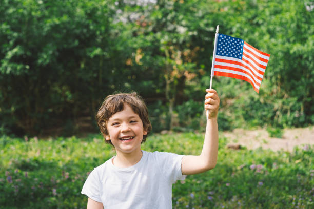istock Patriotic boy holding American flag 1399009785