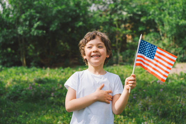 istock Patriotic boy holding American flag 1399009887