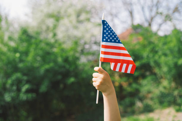 istock Patriotic boy holding American flag 1399009964