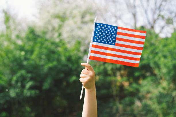 istock Patriotic boy holding American flag 1399009982