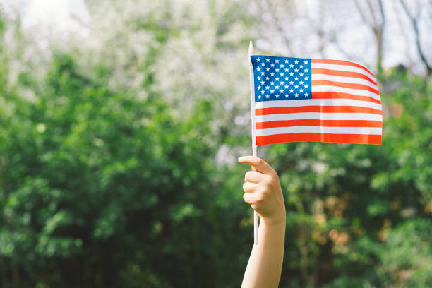 istock Patriotic boy holding American flag 1399010020