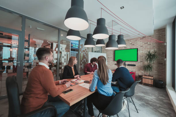 istock Successful team. Group of young multi-ethnic business people working and communicating together in creative office. Selective focus 1399012393