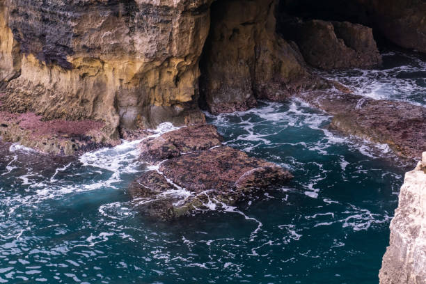 istock Vibrant turquoise ocean waves crash against the rocks 1399012892