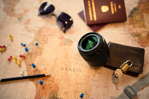 Sony Alpha 7 III, 35mm F 1,8. Travel equipment such as passports, glasses, camera lens, wallet, keys on a latin america map.