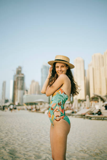 istock Young woman walks towards beautiful beach 1399013886