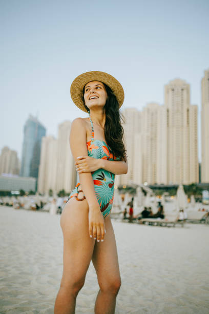 istock Young woman walks towards beautiful beach 1399013950