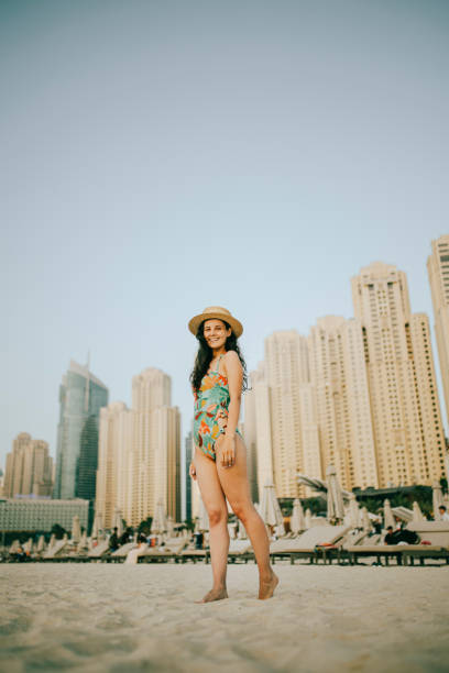 istock Young woman walks towards beautiful beach 1399014032