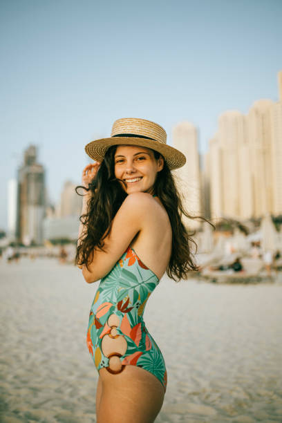 istock Young woman walks towards beautiful beach 1399014270