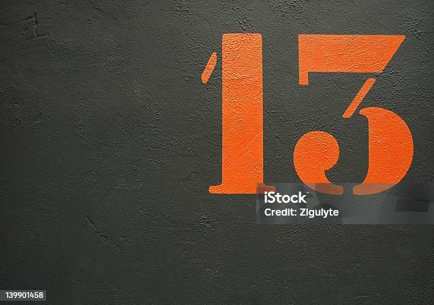 An Orange Stenciled Number 13 On A Black Background Stock Photo - Download Image Now