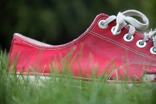 Close-up of an old red shoe that is worn out