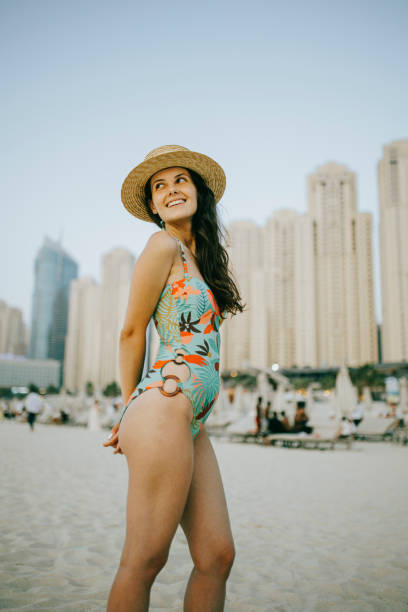 istock Young woman walks towards beautiful beach 1399015656