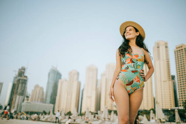 istock Young woman walks towards beautiful beach 1399015682