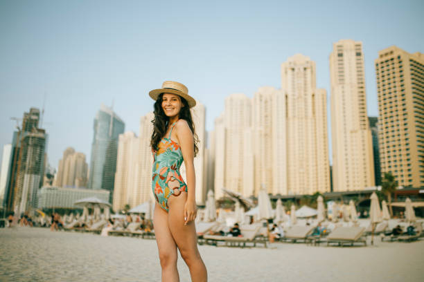 istock Young woman walks towards beautiful beach 1399015927
