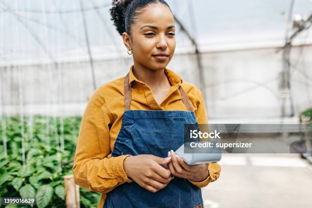 Woman Holding Card Reader Int He Greenhouse Stock Photo - Download Image Now - Credit Card Reader, Business, Females