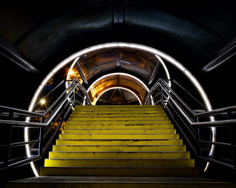 Yellow Steps lead up a tunnel with light rings at night, Case Western Reserve University, Cleveland, Ohio.