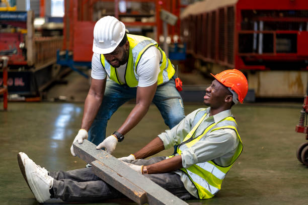 istock African American factory worker having accident while working in manufacturing site while his colleague is helping  for safety workplace and emergency concept 1399017139