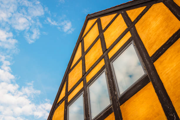 istock low angle of an orange house with timber framing and cloudy sky 1399017168