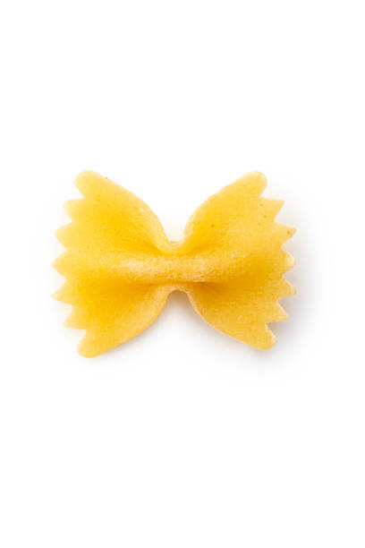 High angle view, close-up on one raw bow tie pasta, farfalle, on white background