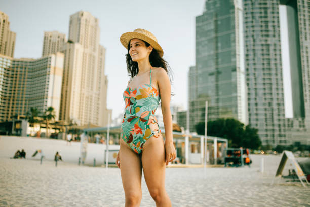 istock Young woman walks towards beautiful beach 1399017282