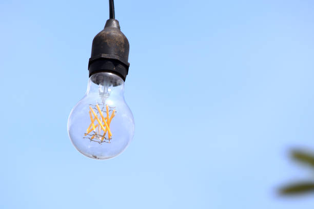 istock closeup led light bulb hanging with blue background 1399017317