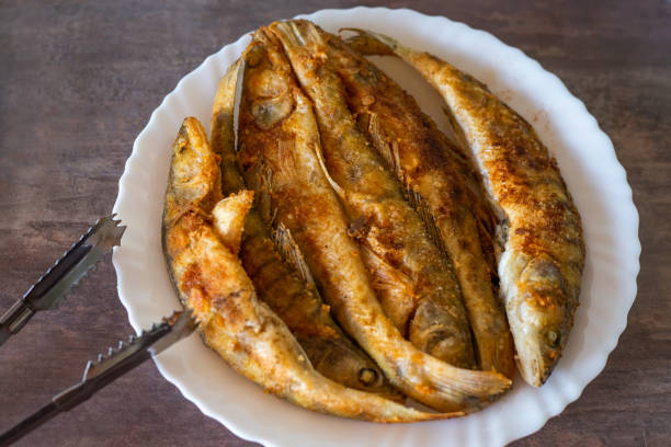 istock Fried whole zander fish on a white plate. Cooking at home 1399017358