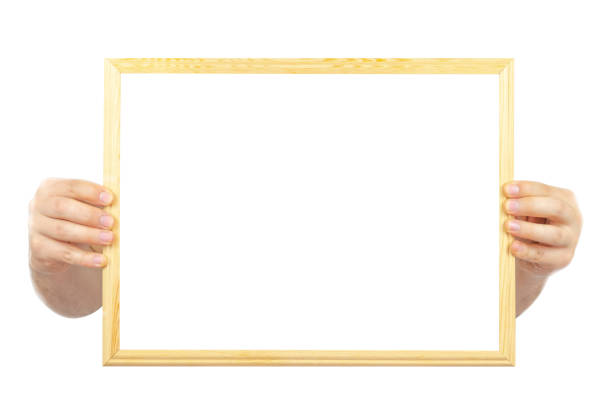 istock Hand holding wooden frame with copy space, isolated on white background, white area for text on timber frame, remarkable image for advertising banner, message text concept 1399017571