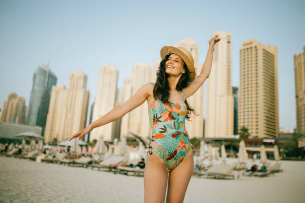 istock Young woman walks towards beautiful beach 1399017605