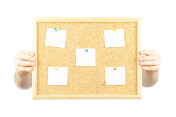 istock Hand holding cork pinboard with five pinned paper with copy space, isolated on white background, paper area for text on wooden cork board, banner idea 1399018363
