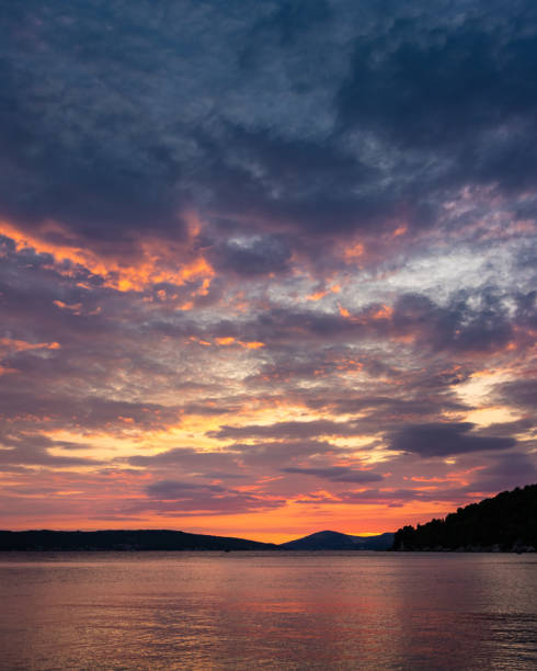 istock cloudy sky at sunrise or sunset over the sea coast 1399018937