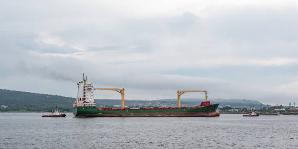 istock container ship being maneuvered by a tugboat 1399022860