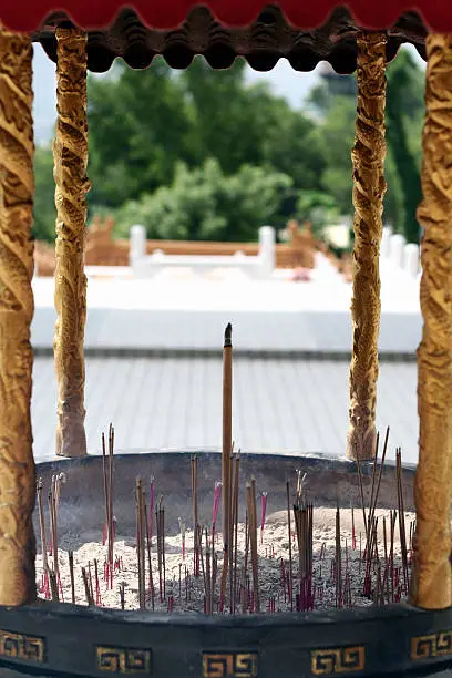 A joss-stick pit with golden bars on the side.