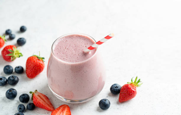 Strawberry blueberry smoothie or milkshake stock photo