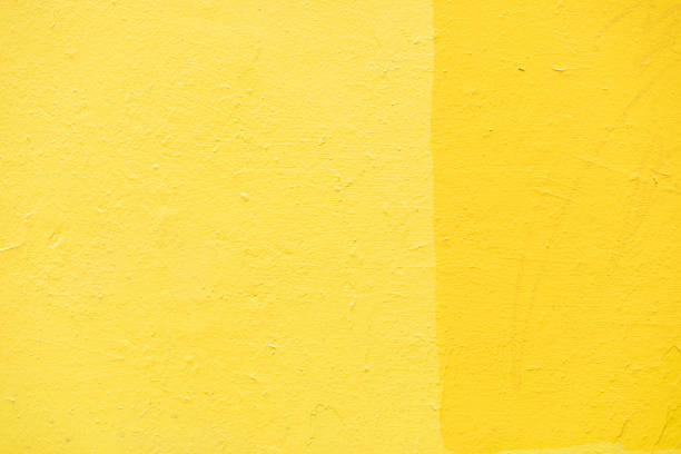 Yellow wall texture. Background yellow paint on wall. Bright color. Painted surface.