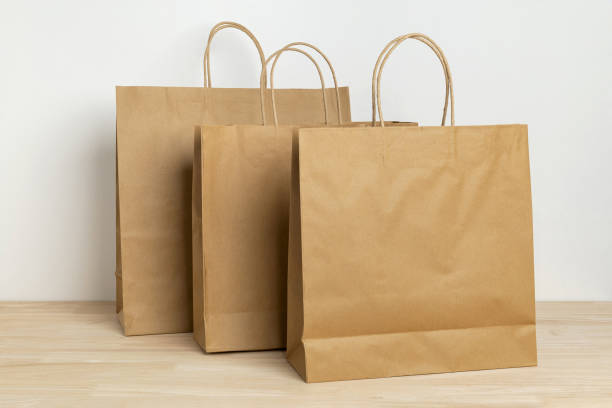 istock three brown paper bag on wooden table for mockup blank template 1399027797