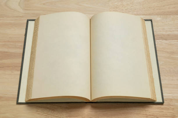 istock open old book on wooden table for mockup blank template 1399027836