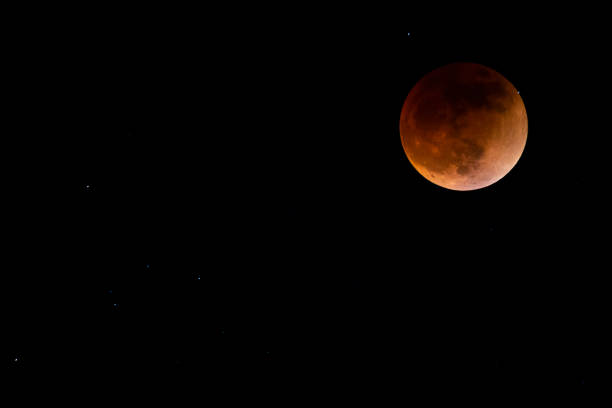 Moon and stars in the sky during the total moon eclipse Moon and stars in the sky during the total moon eclipse May 15, 2022 penumbral lunar eclipse stock pictures, royalty-free photos & images