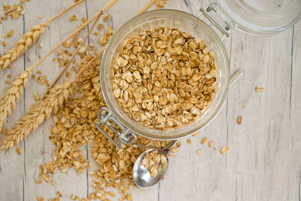 Dry oatmeal in a jar on a wooden background