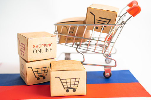 Box with shopping online cart logo and Russia flag, Import Export Shopping online or commerce finance delivery service store product shipping, trade, supplier concept.