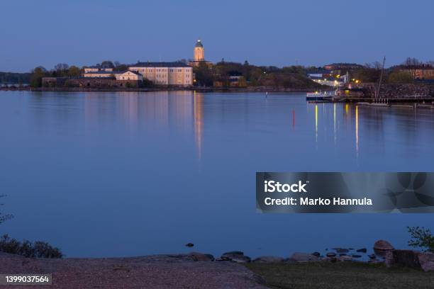 Suomenlinna Fortress Across The River A Lighthouse Casting Reflections On The Calm Sea Stock Photo - Download Image Now