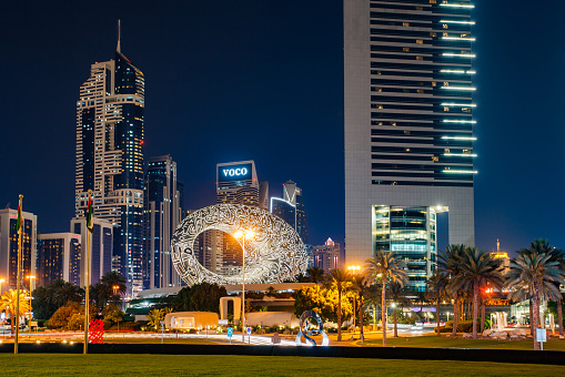 Dubai, UAE - April 21, 2022: Museum of The Future, Jumeirah Emirates Towers, Voco, Blue Tower, at night.
