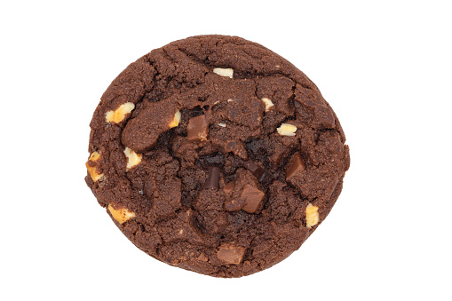 One homemade round shaped chocolate cookie with chocolate pieces isolated on a white background with a close up, top view.